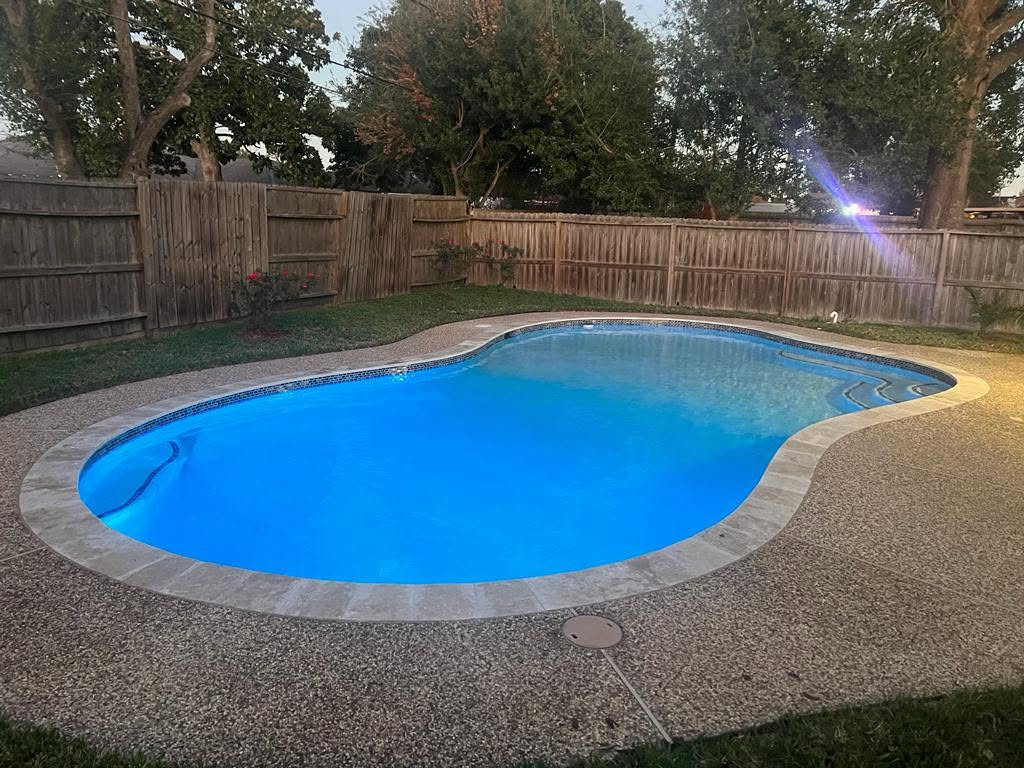 Newly renovated backyard swimming pool by Cannonball Pool Renovations in Houston